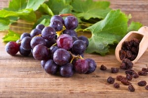 grapes and raisins on a hardwood table